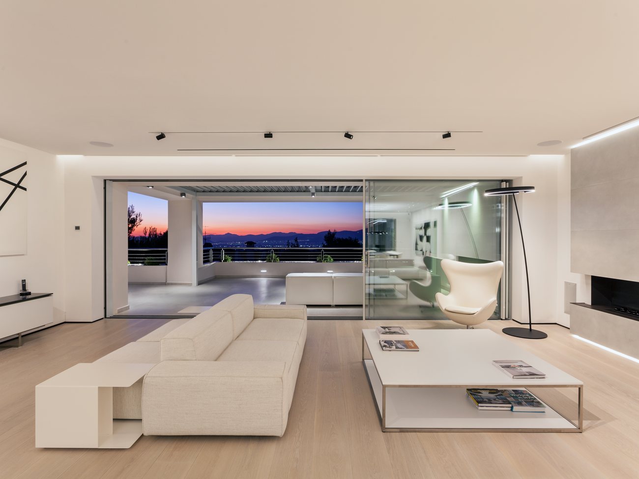 Politeia residence, Athens — living room opening onto the terrace at sunset, AKPRAXIS architecture and construction