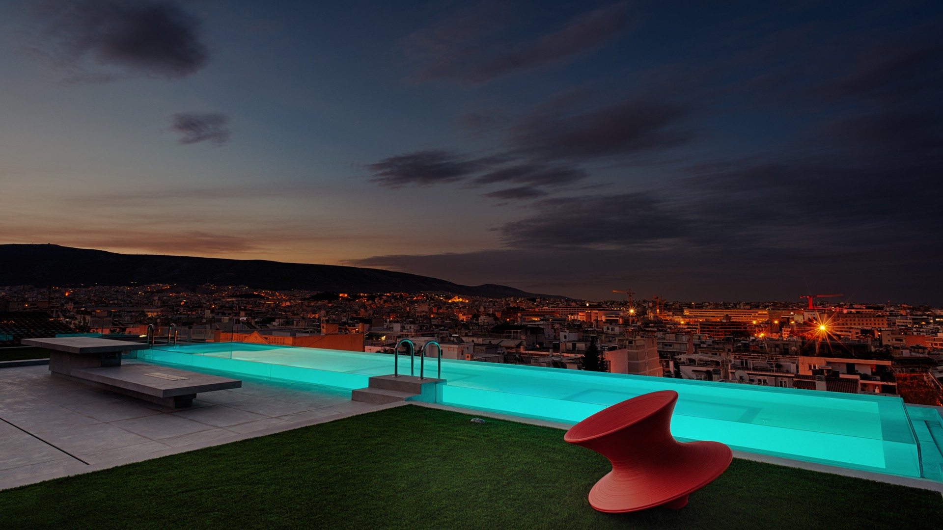 Rooftop pool at dusk overlooking Athens — Filopappou residence, AKPRAXIS