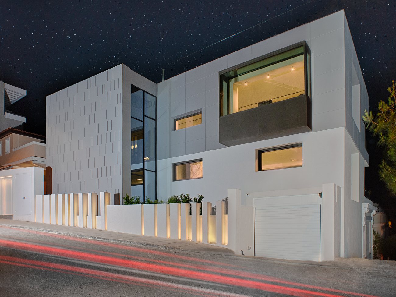 Filopappou Hill residence, Athens — night exterior of the white modern house under a starry sky, AKPRAXIS architecture and construction